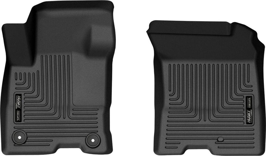 Husky Liners X-act Contour Floor Liners: Two black front floor liners on white, driver side with two retention holes