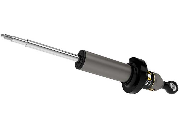 ICON Vehicle Dynamics 2.5 EXP Series Coilover: ICON 2.5 EXP front coilover body with spring perch and eyelet base laid nearly horizontal on white; stem end runs to frame edge