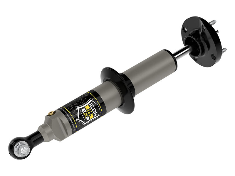 ICON Vehicle Dynamics 2.5 EXP Series Coilover: ICON 2.5 EXP front coilover with round three-stud top plate, spring perch and eyelet base, laid diagonally on white