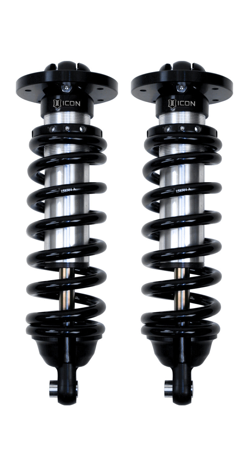 ICON Vehicle Dynamics 2.5 Series Coilover Kit: a pair of ICON 2.5 VS internal-reservoir front coilovers with black springs, round tops and eyelet lower mounts, on white