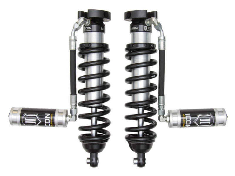 ICON Vehicle Dynamics 2.5 Series Coilover Kit: a pair of ICON 2.5 VS remote-reservoir coilovers with black springs and silver ICON reservoirs held out horizontally on hoses, on white
