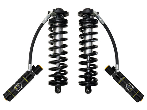 ICON Vehicle Dynamics 2.5 Series Coilover Kit: a pair of ICON 2.5 VS remote-reservoir coilovers with black springs and black electronic-valve reservoirs angled out and down, on white