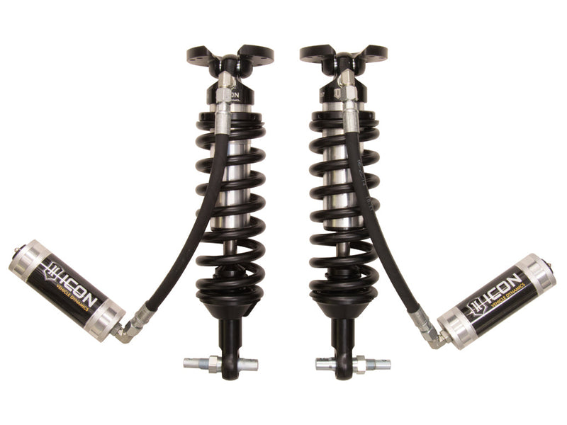 ICON Vehicle Dynamics 2.5 Series Coilover Kit: a pair of ICON 2.5 VS remote-reservoir coilovers with black springs, bar-pin bases and silver ICON reservoirs angled out to the sides, on white
