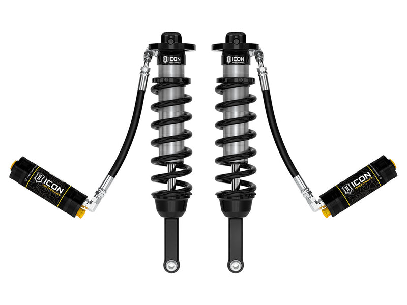 ICON Vehicle Dynamics 2.5 Series Coilover Kit: a pair of ICON 2.5 VS remote-reservoir coilovers with black springs and black ICON reservoirs held low to the sides on long hoses, on white