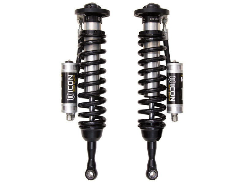 ICON Vehicle Dynamics 2.5 Series Coilover Kit: a pair of ICON 2.5 VS remote-reservoir coilovers with black springs and silver ICON reservoirs mounted close to the bodies, on white