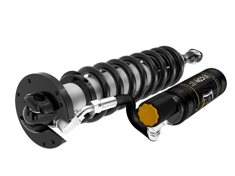 ICON Vehicle Dynamics 2.5 Series Coilover Kit: single ICON 2.5 VS remote-reservoir coilover with black spring laid horizontally beside its CDEV reservoir on white