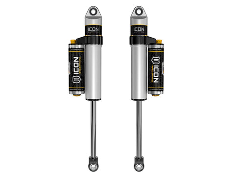 ICON Vehicle Dynamics 2.5 Series Shock Absorbers: a pair of silver ICON 2.5 aluminum series shocks with clamped piggyback reservoirs and eyelet ends, rendered on white