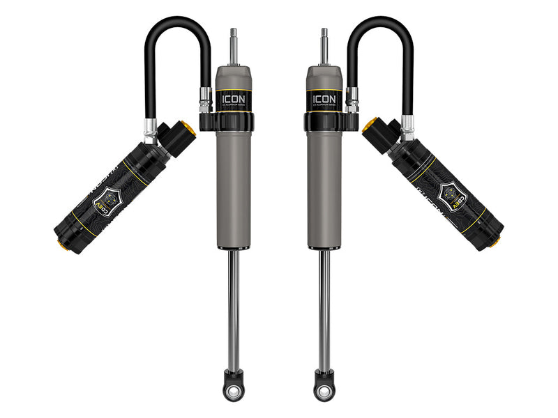 ICON Vehicle Dynamics 2.5 Series Shock Absorbers: rendered pair of gray ICON 2.5 aluminum series shocks with CDEV reservoirs angled out on looped hoses, on white