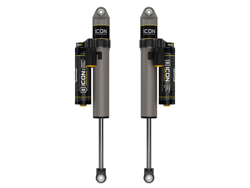 ICON Vehicle Dynamics 2.5 Series Shock Absorbers: rendered pair of gray ICON 2.5 aluminum series shocks with CDEV piggyback reservoirs and eyelet ends on white