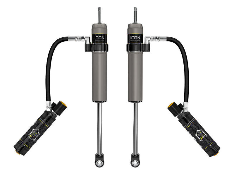 ICON Vehicle Dynamics 2.5 Series Shock Absorbers: rendered pair of gray ICON 2.5 aluminum series shocks with CDEV remote reservoirs angled outward on hoses, on white