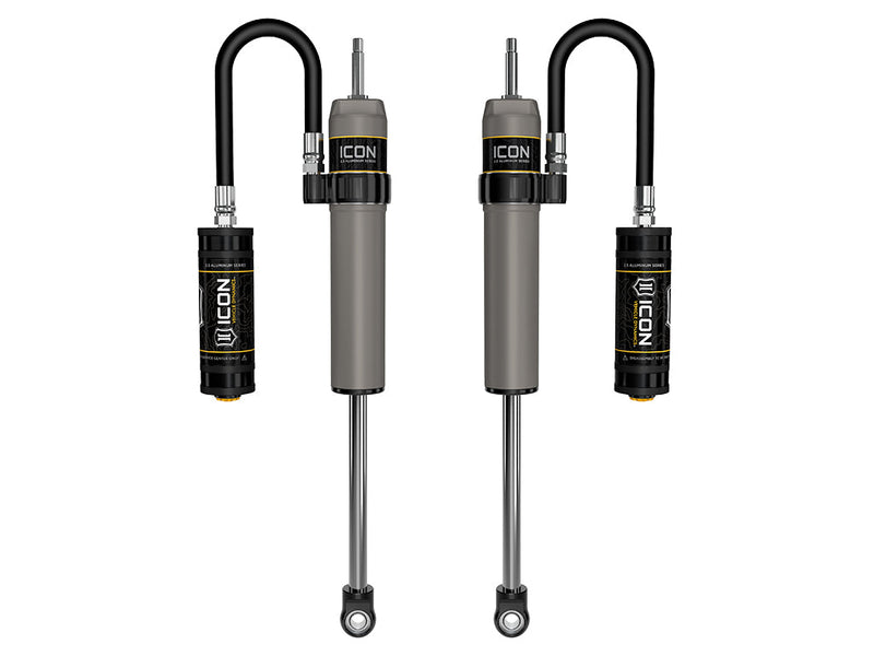 ICON Vehicle Dynamics 2.5 Series Shock Absorbers: rendered pair of gray ICON 2.5 aluminum series shocks with remote reservoirs on looped hoses, stem tops and eyelet bases on white (part 57840P)