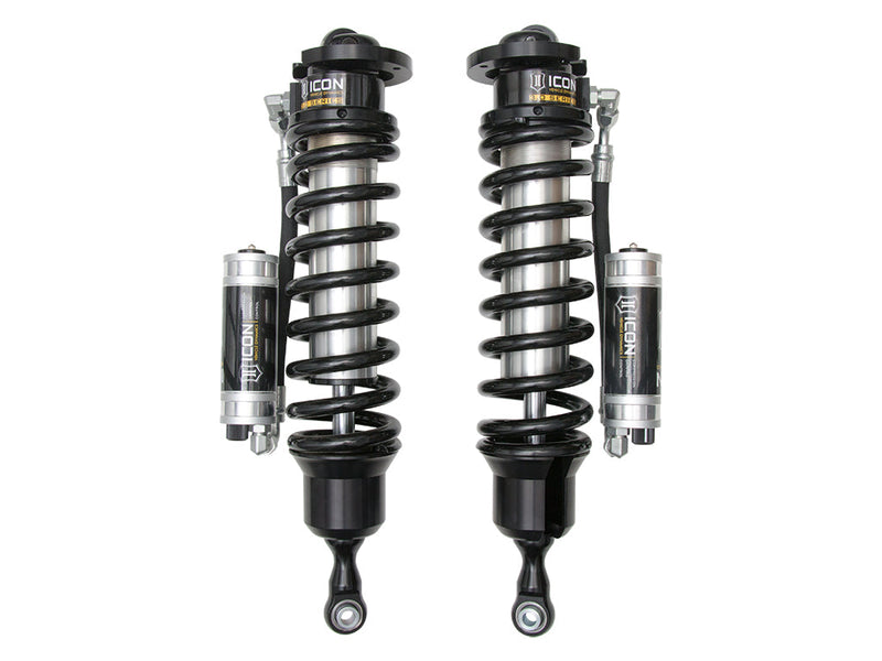 ICON Vehicle Dynamics 3.0 Series Coilover: a pair of ICON 3.0 VS remote-reservoir coilovers with black springs and silver CDC reservoirs mounted beside the bodies, on white