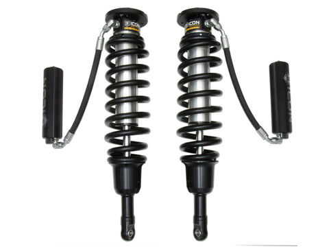 ICON Vehicle Dynamics 3.0 Series Coilover: photograph of a pair of ICON 3.0 VS remote-reservoir coilovers with black springs and finned black reservoirs on hoses, on white