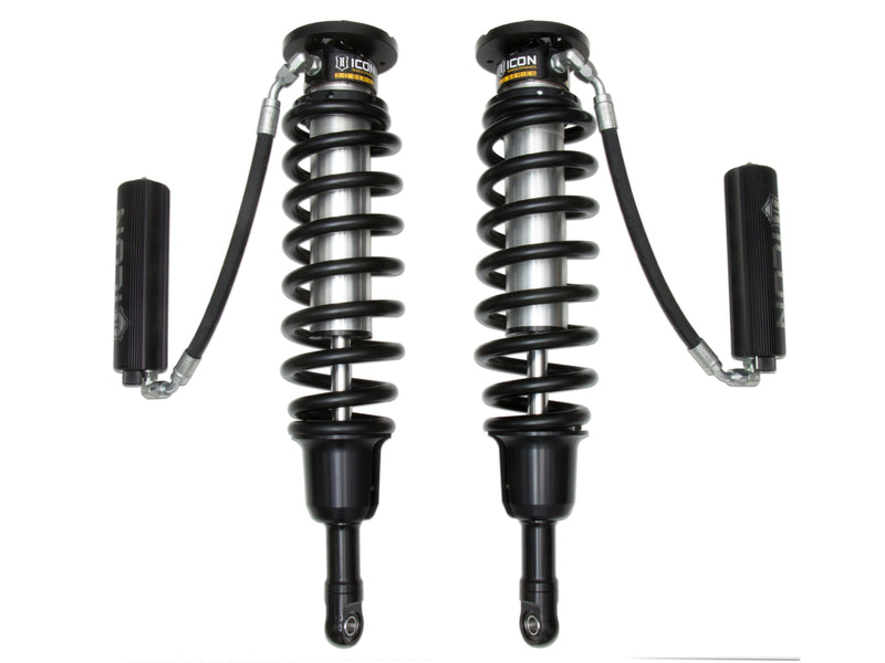 ICON Vehicle Dynamics 3.0 Series Coilover: photograph of a pair of ICON 3.0 VS remote-reservoir coilovers with black springs and finned black reservoirs on hoses, on white