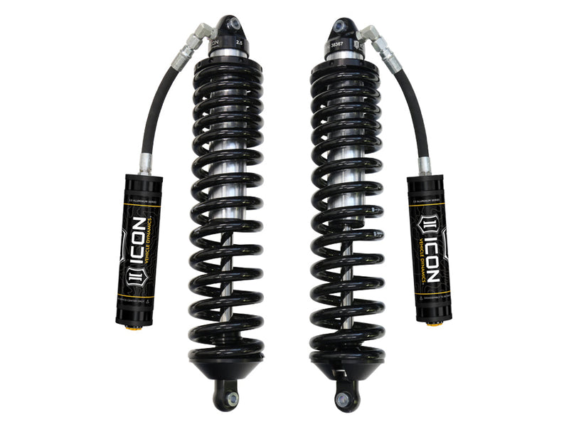 A pair of ICON 2.5 VS remote-reservoir coilovers with long black springs, eyelet ends and black ICON 2.5 Aluminum Series reservoirs, on white.
