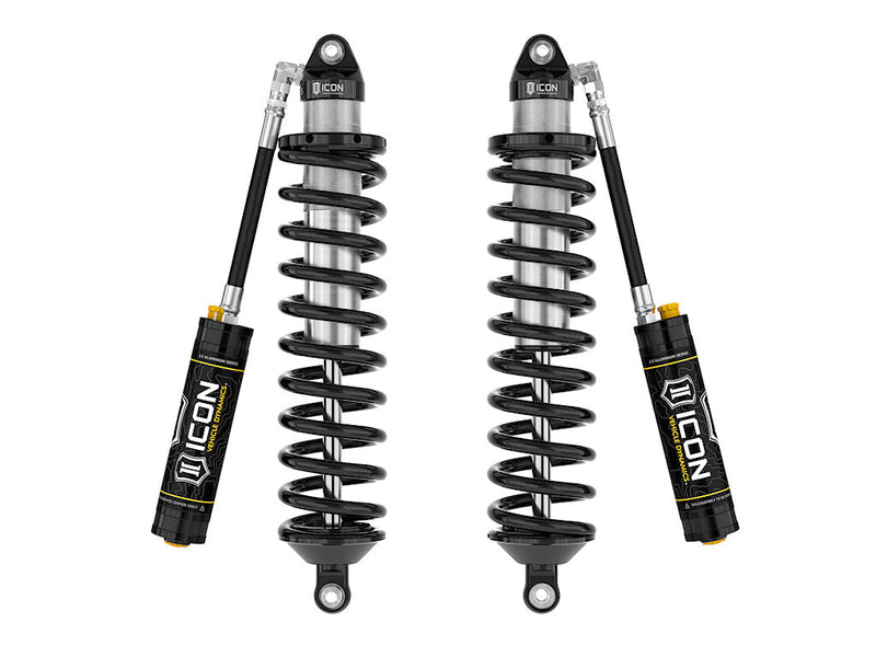 A pair of ICON 2.5 VS remote-reservoir coilovers with black springs, eyelet top and bottom mounts and black ICON reservoirs, on white.