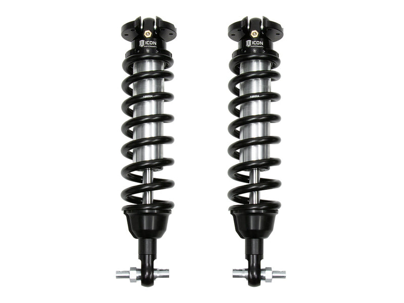 A pair of ICON 2.5 VS internal-reservoir front coilovers with black springs and bar-pin lower mounts, on white.