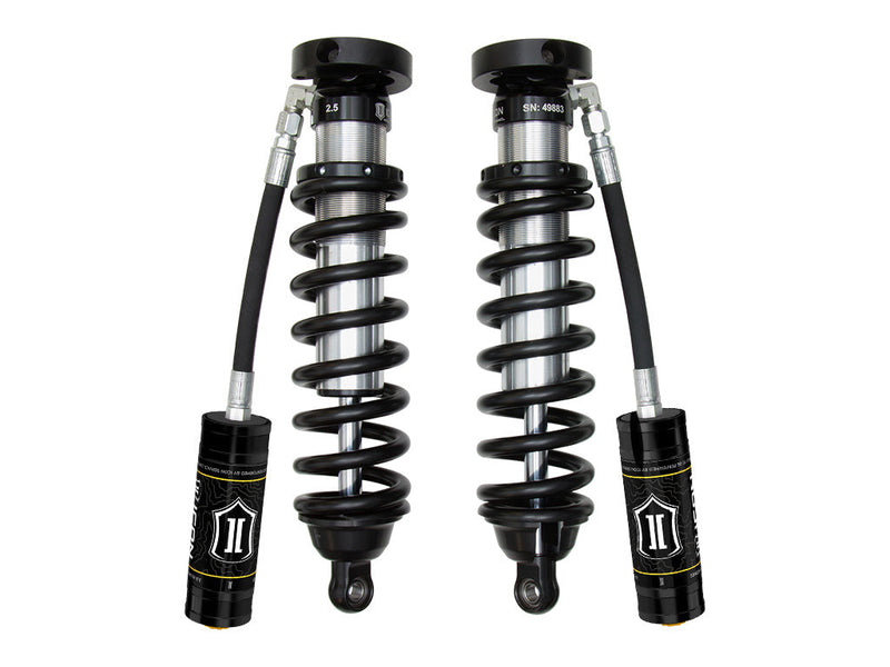 A pair of ICON 2.5 VS remote-reservoir coilovers with black springs and black ICON reservoirs hanging beside them, on white.