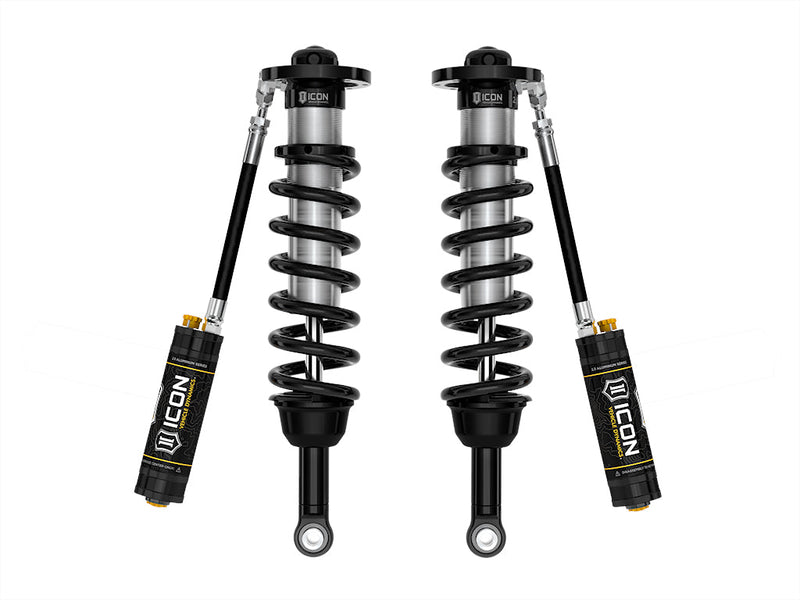 A pair of ICON 2.5 VS remote-reservoir coilovers with black springs and black ICON 2.5 Aluminum Series reservoirs angled below, on white.