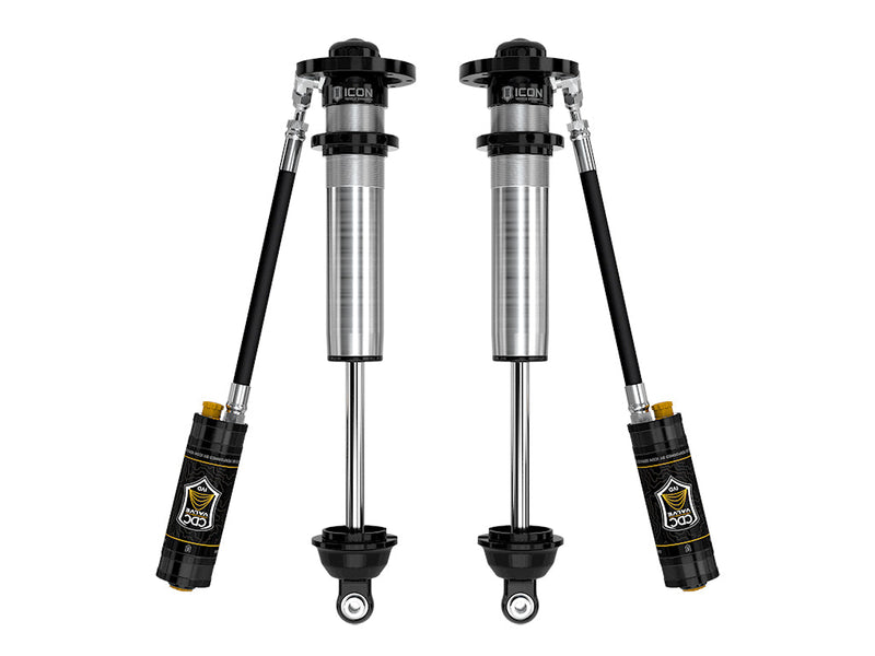 A pair of ICON 2.5 VS remote-reservoir long-travel coilover bodies without springs, with CDC Valve reservoirs angled below, on white.