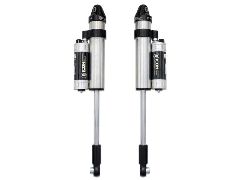 A pair of silver ICON 2.5 VS piggyback shocks with CDC reservoirs and fork lower mounts, photographed on white.