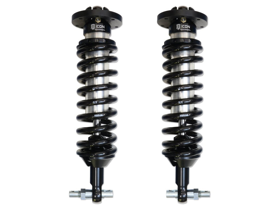 A pair of ICON 2.5 VS internal-reservoir front coilovers with black springs, round tops and bar-pin lower mounts, on white.