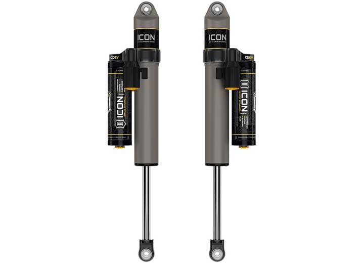 Rendered pair of gray ICON 2.5 aluminum series shocks with CDEV piggyback reservoirs and eyelet ends on white.