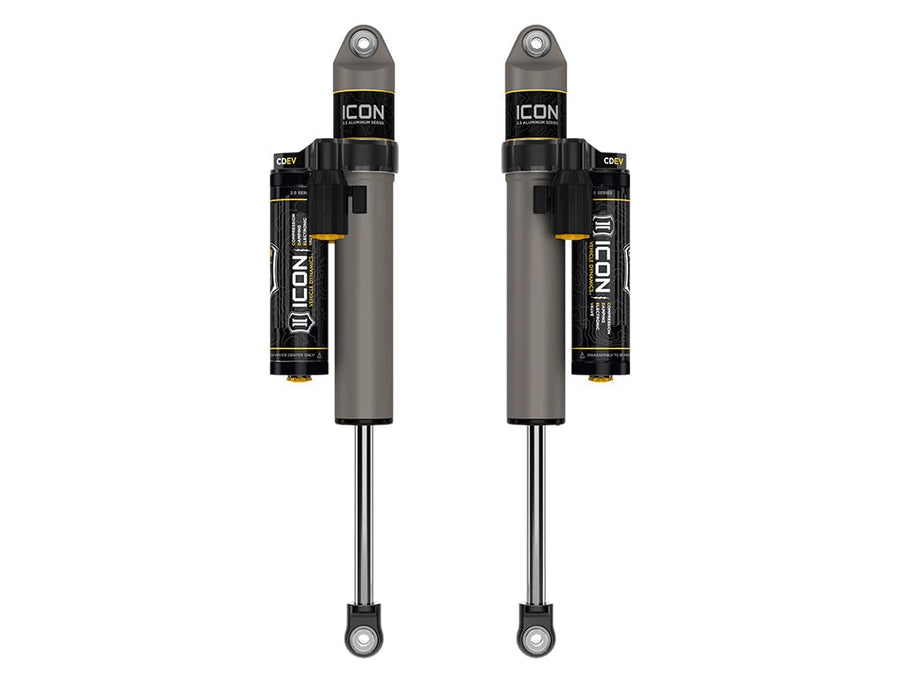 Rendered pair of gray ICON 2.5 aluminum series shocks with CDEV piggyback reservoirs and eyelet ends on white.