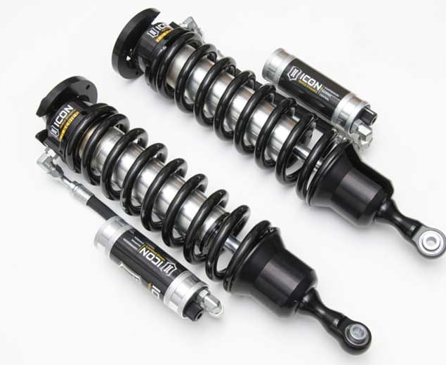 Photograph of two ICON 3.0 VS remote-reservoir coilovers with black springs laid diagonally beside their silver reservoirs on a light gray backdrop.