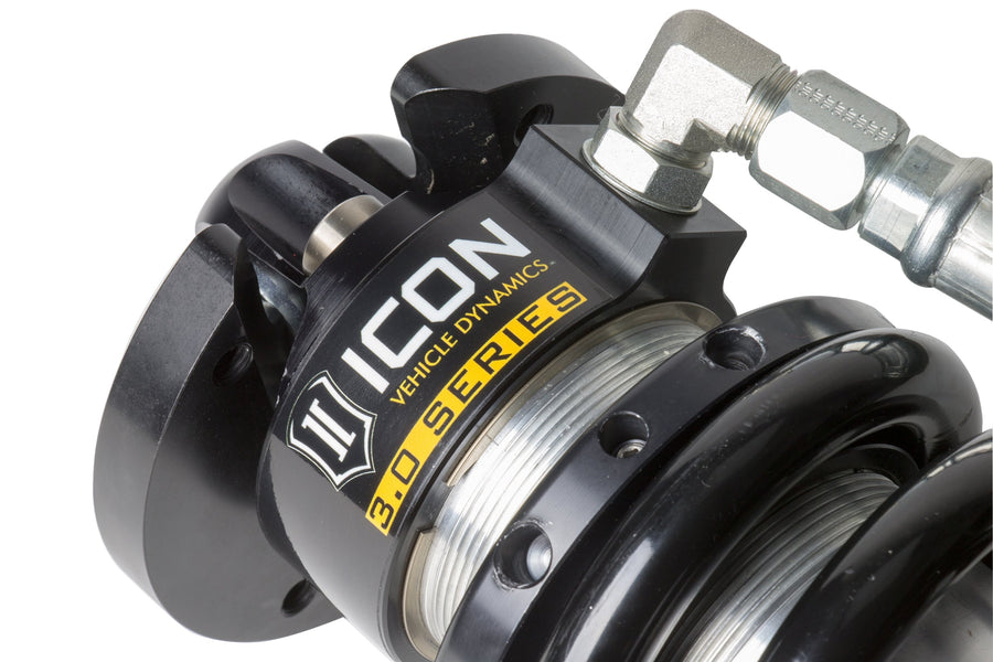 Close-up of an ICON 3.0 Series coilover top cap with ICON Vehicle Dynamics 3.0 Series label, spring seat and braided hose fitting.