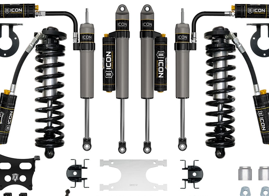 Studio kit layout on white: coilover conversion kit: remote-reservoir front coilovers, four reservoir rear shocks, dual steering stabilizer shocks, track bar, brackets and spacers.