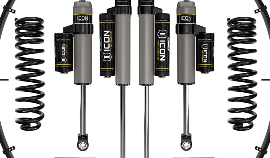 Studio kit layout on white: Stage kit: front coil springs, four piggyback-reservoir shocks, rear leaf packs and U-bolts.