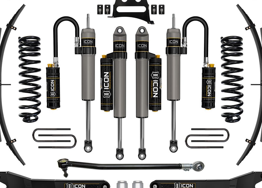 Studio kit layout on white: Stage kit: front coil springs, remote-reservoir and piggyback shocks, rear leaf packs, dual steering stabilizers, track bar, ICON radius arms and bracket.