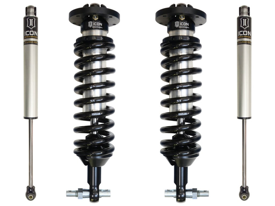 ICON Stage 1 set for GM 1500 on white: two front 2.5 coilovers and two silver 2.0 rear shocks.