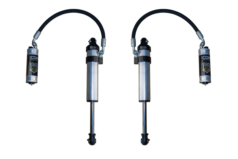 Pair of ICON 2.5 Series remote reservoir shocks with hoses on white