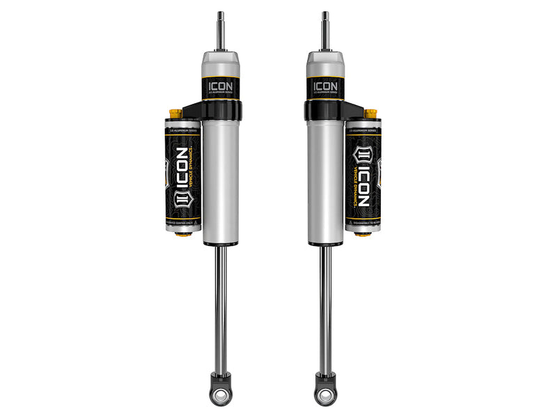 Rendered pair of silver ICON 2.5 aluminum series shocks with clamped piggyback reservoirs, stem tops and eyelet bases on white.