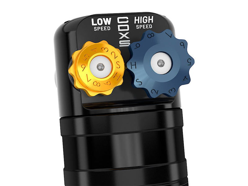 Close-up of the CDXS reservoir cap showing the gold low-speed and blue high-speed numbered adjuster knobs.