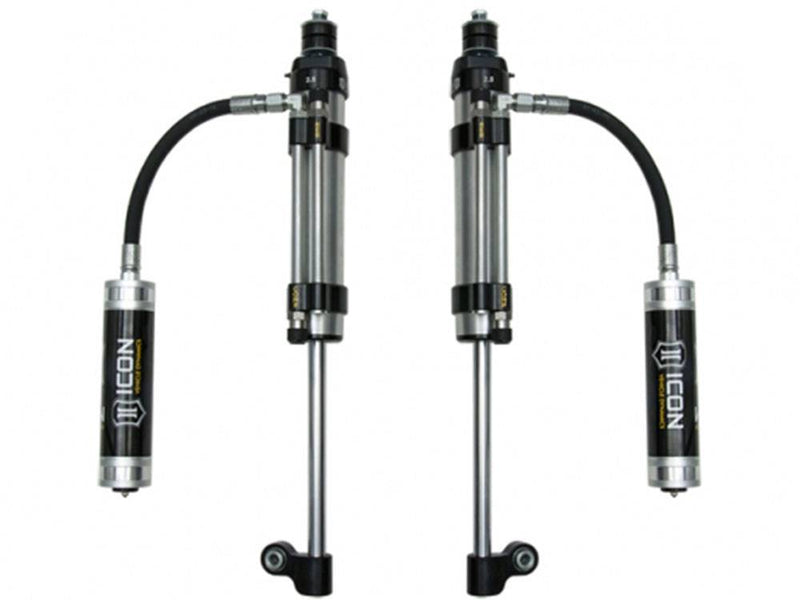 Pair of ICON Omega series remote reservoir shocks with hoses on white