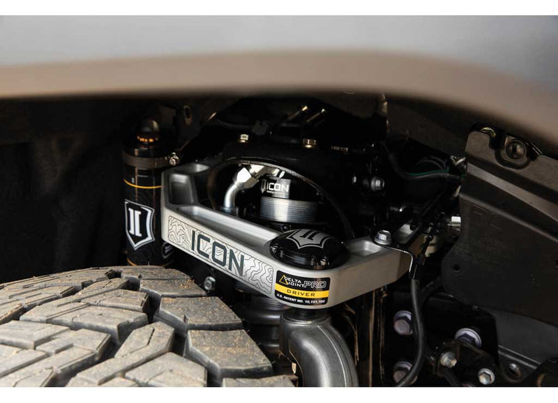 Close-up of an installed ICON billet upper control arm with Delta Joint PRO label above an all-terrain tire.