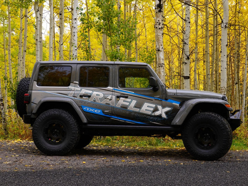 TeraFlex 2.5" Trail Select Adventure Kit installed on a gray Jeep Wrangler JL, side view in an aspen forest