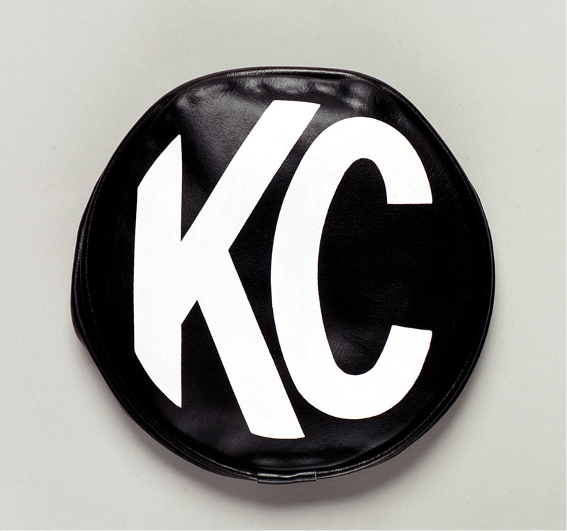 KC HiLiTES 6" Round Light Cover & Shield on a studio background: round black soft vinyl light cover with a white KC logo on a light gray background