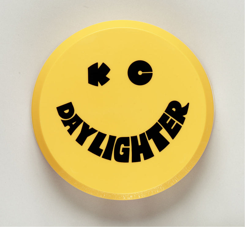 KC HiLiTES 6" Round Light Cover & Shield on a studio background: round yellow hard plastic KC Daylighter light cover with a black smiley face logo on a light gray background
