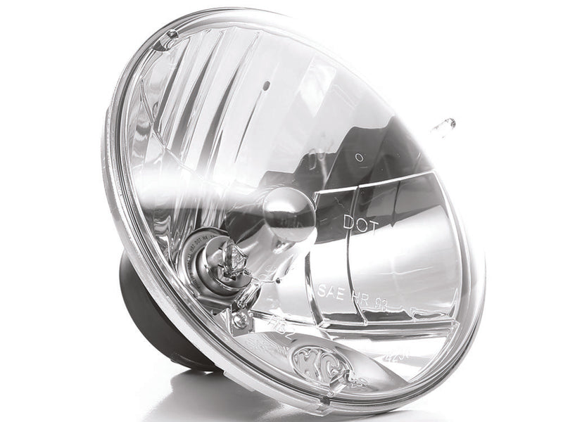 KC HiLiTES 7" H4 DOT Halogen Headlight Pair with H13 Adapters on a studio background: close angled view of a 7" clear halogen headlight lens with DOT and SAE markings and the H4 bulb