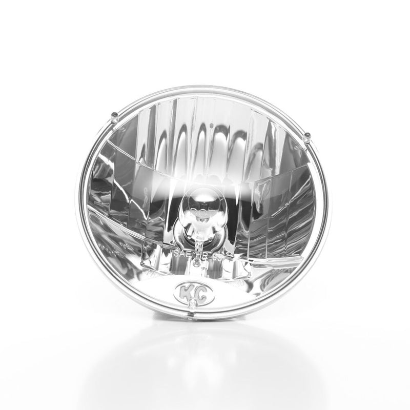 KC HiLiTES 7" H4 DOT Halogen Headlight Pair with H13 Adapters on a studio background: front view of a round 7" clear halogen headlight with KC logo at the bottom of the lens