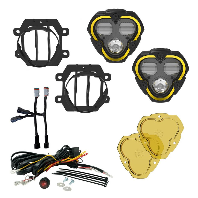 KC HiLiTES FLEX ERA 3 Dual-Mode SAE Fog Light Kit on a studio background: FLEX ERA 3 fog light kit laid out: two lights, Subaru brackets, harness adapters, wiring harness with switch and two yellow lenses