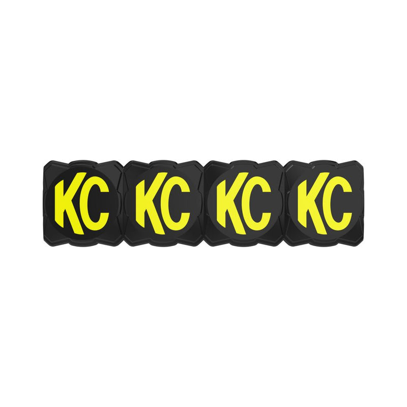 KC HiLiTES FLEX ERA LED Light Bar 10" Cover & Shield on a studio background: black FLEX ERA light bar cover with four yellow KC logos, front view