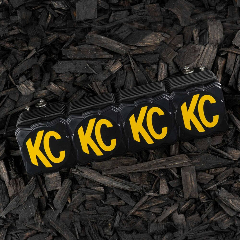 KC HiLiTES FLEX ERA LED Light Bar 10" Cover & Shield on a vehicle: FLEX ERA light bar with black KC covers resting on dark wood mulch