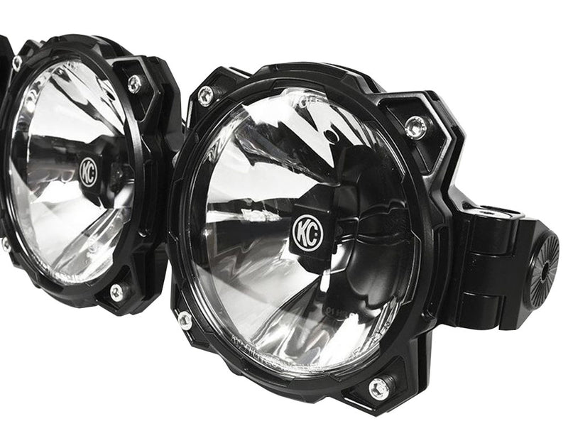 Close-up of the KC HiLiTES Gravity Pro6 LED Light Bar: close-up of two round black LED light pods with clear reflectors and a bar clamp mount