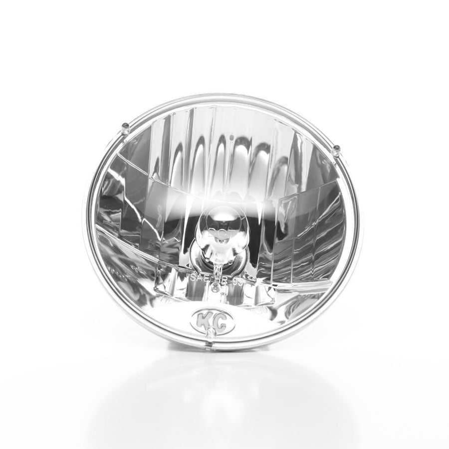 Jeep & 7" Round Headlights by KC HiLiTES: Front view of a round 7 inch clear halogen headlight with KC logo at the bottom of the lens
