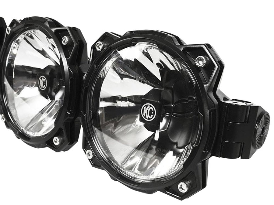 Gravity Pro6 LED Light Bars by KC HiLiTES: Close-up of two round black LED light pods with clear reflectors and a bar clamp mount